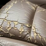Closeup of cracked leather car seat before repair