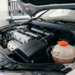 Driver adding coolant to a car reservoir safely